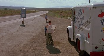Movie still from “The Wizard” (1989), directed by Todd Holland – A young boy standing on the side of a road holding a map; Wide shot, Low angle