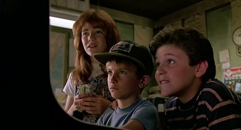 Movie still from “The Wizard” (1989), directed by Todd Holland – Three children sitting in front of a television; Close Up shot, Low angle