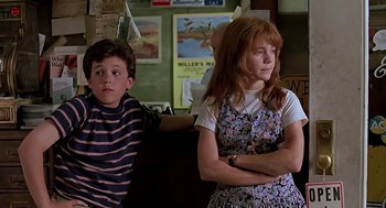 Movie still from “The Wizard” (1989), directed by Todd Holland – A boy and a girl sitting next to each other in a room; Medium shot, Low angle
