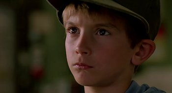 Movie still from “The Wizard” (1989), directed by Todd Holland – A young boy wearing a hat looking at the camera; Close Up shot, Low angle