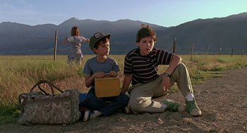 Movie still from “The Wizard” (1989), directed by Todd Holland – Two young boys sitting on the ground in a field; Wide shot, Low angle