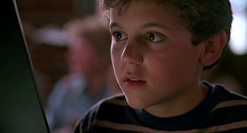Movie still from “The Wizard” (1989), directed by Todd Holland – A young boy's face looking at the camera; Close Up shot, High angle