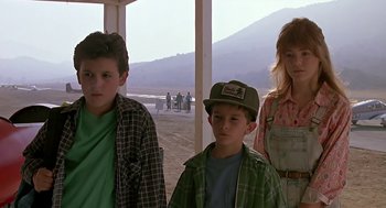 Movie still from “The Wizard” (1989), directed by Todd Holland – Three children standing in front of an open field; Medium shot, Low angle