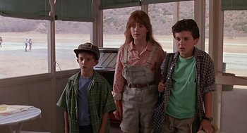 Movie still from “The Wizard” (1989), directed by Todd Holland – Three children standing next to each other in front of a window; Medium shot, Low angle