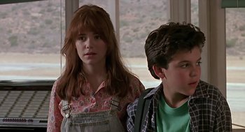 Movie still from “The Wizard” (1989), directed by Todd Holland – A girl and a boy sitting next to each other in front of a window; Close Up shot, Over the shoulder angle
