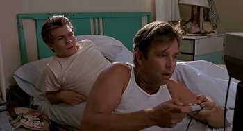Movie still from “The Wizard” (1989), directed by Todd Holland – Two men in white shirts in a bed; Medium shot, Low angle