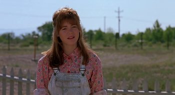 Movie still from “The Wizard” (1989), directed by Todd Holland – A woman standing in front of a fence; Close Up shot, Over the shoulder angle