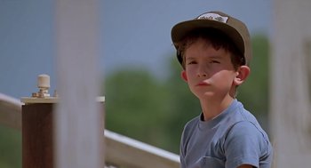 Movie still from “The Wizard” (1989), directed by Todd Holland – A young boy wearing a baseball cap looking at the camera; Close Up shot, Low angle
