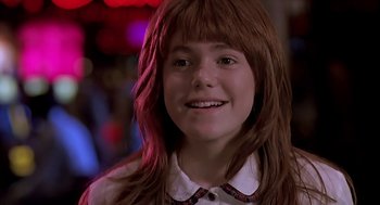 Movie still from “The Wizard” (1989), directed by Todd Holland – A young girl with long red hair smiling for the camera; Close Up shot, Low angle