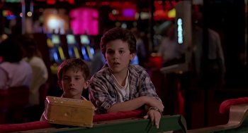 Movie still from “The Wizard” (1989), directed by Todd Holland – Two young boys sitting at a table in front of a slot machine; Close Up shot, Low angle