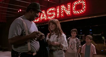 Movie still from “The Wizard” (1989), directed by Todd Holland – A man and a woman standing in front of a casino sign; Medium shot, Over the shoulder angle