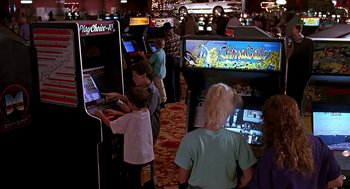 Movie still from “The Wizard” (1989), directed by Todd Holland – A group of people playing a video game in an arcade; Wide shot, High angle