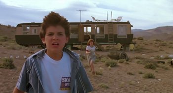Movie still from “The Wizard” (1989), directed by Todd Holland – A young boy and a young girl running in the desert; Medium shot, Low angle