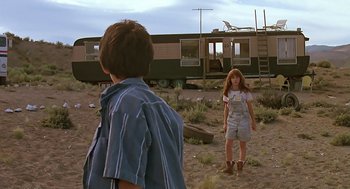 Movie still from “The Wizard” (1989), directed by Todd Holland – Two children standing in a dirt field near a trailer; Wide shot, Low angle