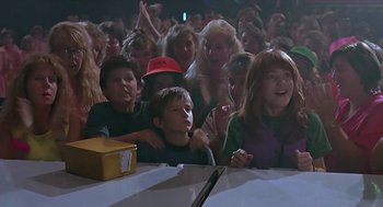 Movie still from “The Wizard” (1989), directed by Todd Holland – A group of people sitting around a table; Medium shot, High angle