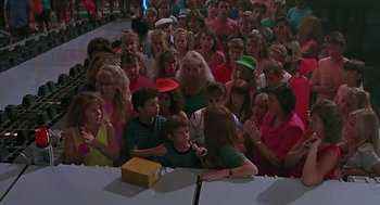 Movie still from “The Wizard” (1989), directed by Todd Holland – A group of people standing around a table; Wide shot, High angle
