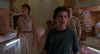 Movie still from “The Wizard” (1989), directed by Todd Holland – A young boy standing in front of a group of people; Medium shot, Over the shoulder angle