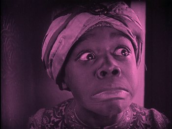 Movie still from “The Wizard of Oz” (1925), directed by Larry Semon – A person wearing a head scarf; Close Up shot, Low angle