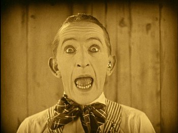Movie still from “The Wizard of Oz” (1925), directed by Larry Semon – An old photo of a man with an open mouth; Close Up shot, High angle