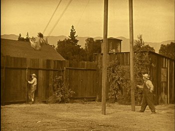 Movie still from “The Wizard of Oz” (1925), directed by Larry Semon – An old photo of men playing a game of baseball; Extreme Wide shot, High angle
