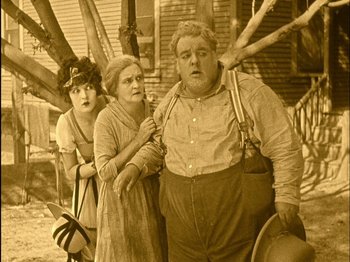 Movie still from “The Wizard of Oz” (1925), directed by Larry Semon – An old photo of two women and an old man; Medium shot, High angle