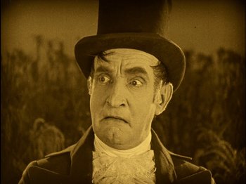 Movie still from “The Wizard of Oz” (1925), directed by Larry Semon – An old photo of a man in a top hat; Close Up shot, Low angle