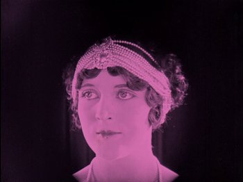 Movie still from “The Wizard of Oz” (1925), directed by Larry Semon – An old photo of a woman wearing a head piece; Close Up shot, Low angle