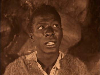 Movie still from “The Wizard of Oz” (1925), directed by Larry Semon – An old photo of a man looking up at the sky; Close Up shot, High angle