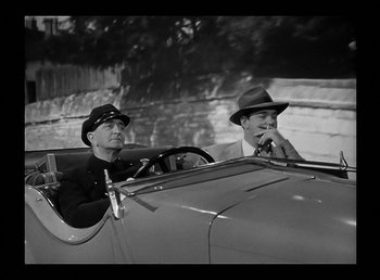 Movie still from “The Wolf Man” (1941), directed by George Waggner – A couple of men sitting in the back seat of a car; Medium shot, Low angle