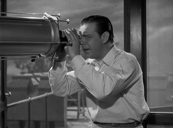 Movie still from “The Wolf Man” (1941), directed by George Waggner – A black and white photo of a man looking through a telescope; Medium shot, High angle