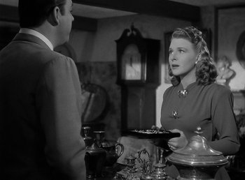 Movie still from “The Wolf Man” (1941), directed by George Waggner – A man and a woman are talking to each other; Medium shot, Over the shoulder angle