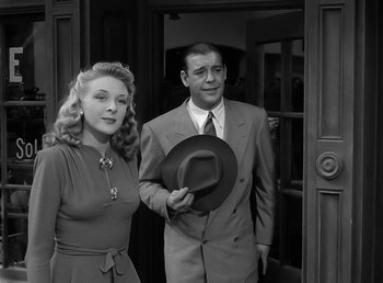 Movie still from “The Wolf Man” (1941), directed by George Waggner – A man and a woman standing next to each other in front of a door; Medium shot, Low angle