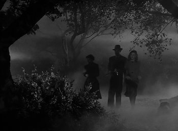 Movie still from “The Wolf Man” (1941), directed by George Waggner – A group of people standing next to each other in the fog; Wide shot, Low angle