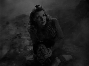 Movie still from “The Wolf Man” (1941), directed by George Waggner – A woman sitting on the ground next to a man; Medium shot, High angle