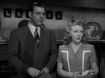 Movie still from “The Wolf Man” (1941), directed by George Waggner – A man and a woman standing next to each other; Medium shot, Low angle