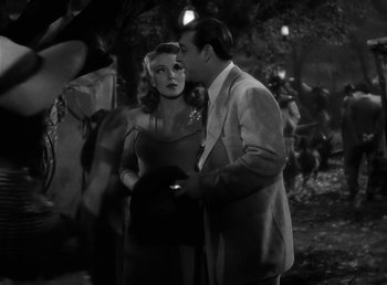 Movie still from “The Wolf Man” (1941), directed by George Waggner – A man and a woman standing next to each other; Medium shot, Over the shoulder angle