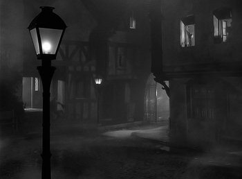 Movie still from “The Wolf Man” (1941), directed by George Waggner – A lamp post in the middle of an empty street; Extreme Wide shot, High angle