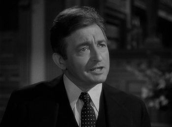 Movie still from “The Wolf Man” (1941), directed by George Waggner – Black and white photograph of a man wearing a suit and tie; Close Up shot, Low angle