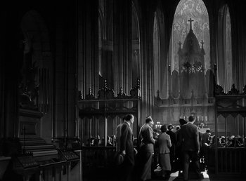 Movie still from “The Wolf Man” (1941), directed by George Waggner – A group of people standing in front of an altar; Extreme Wide shot, Low angle