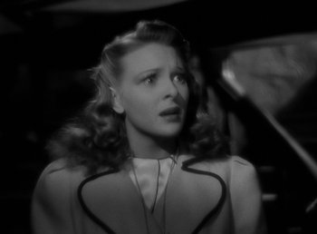 Movie still from “The Wolf Man” (1941), directed by George Waggner – A black - and - white photo of a woman in a dress; Close Up shot, Over the shoulder angle