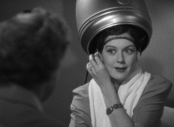 Movie still from “The Women” (1939), directed by George Cukor – A woman getting her hair dried in a hair salon; Close Up shot, Over the shoulder angle