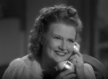 Movie still from “The Women” (1939), directed by George Cukor – An old photo of a woman holding a phone up to her ear; Close Up shot, High angle