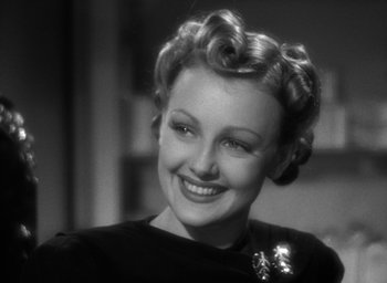 Movie still from “The Women” (1939), directed by George Cukor – An old photo of a woman smiling for the camera; Close Up shot, High angle