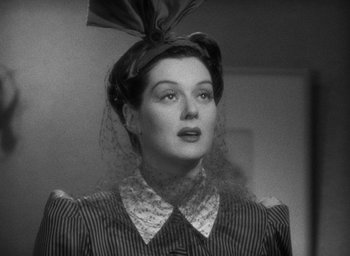 Movie still from “The Women” (1939), directed by George Cukor – A woman with a hat on her head; Close Up shot, Low angle