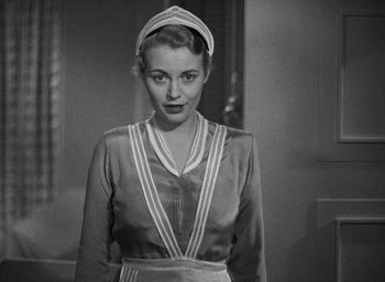 Movie still from “The Women” (1939), directed by George Cukor – A black and white photo of a woman wearing a nurse's hat; Medium shot, Low angle