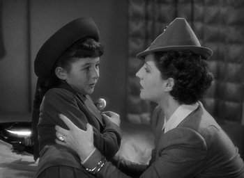 Movie still from “The Women” (1939), directed by George Cukor – An older woman holding a young girl in her arms; Medium shot, High angle