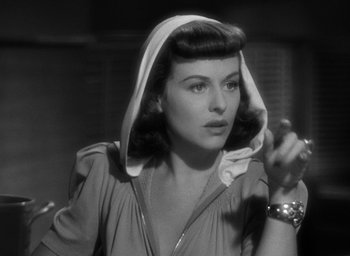 Movie still from “The Women” (1939), directed by George Cukor – A black - and - white photo of a woman with a hood over her head; Close Up shot, Over the shoulder angle