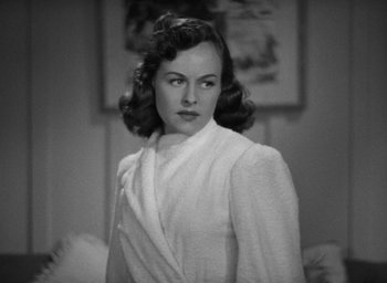 Movie still from “The Women” (1939), directed by George Cukor – A black - and - white photo of a woman in a robe; Close Up shot, High angle