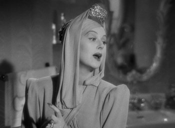 Movie still from “The Women” (1939), directed by George Cukor – A black - and - white photo of a woman wearing a head covering; Close Up shot, Low angle