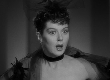 Movie still from “The Women” (1939), directed by George Cukor – An old photo of a woman with a surprised look on her face; Close Up shot, Low angle